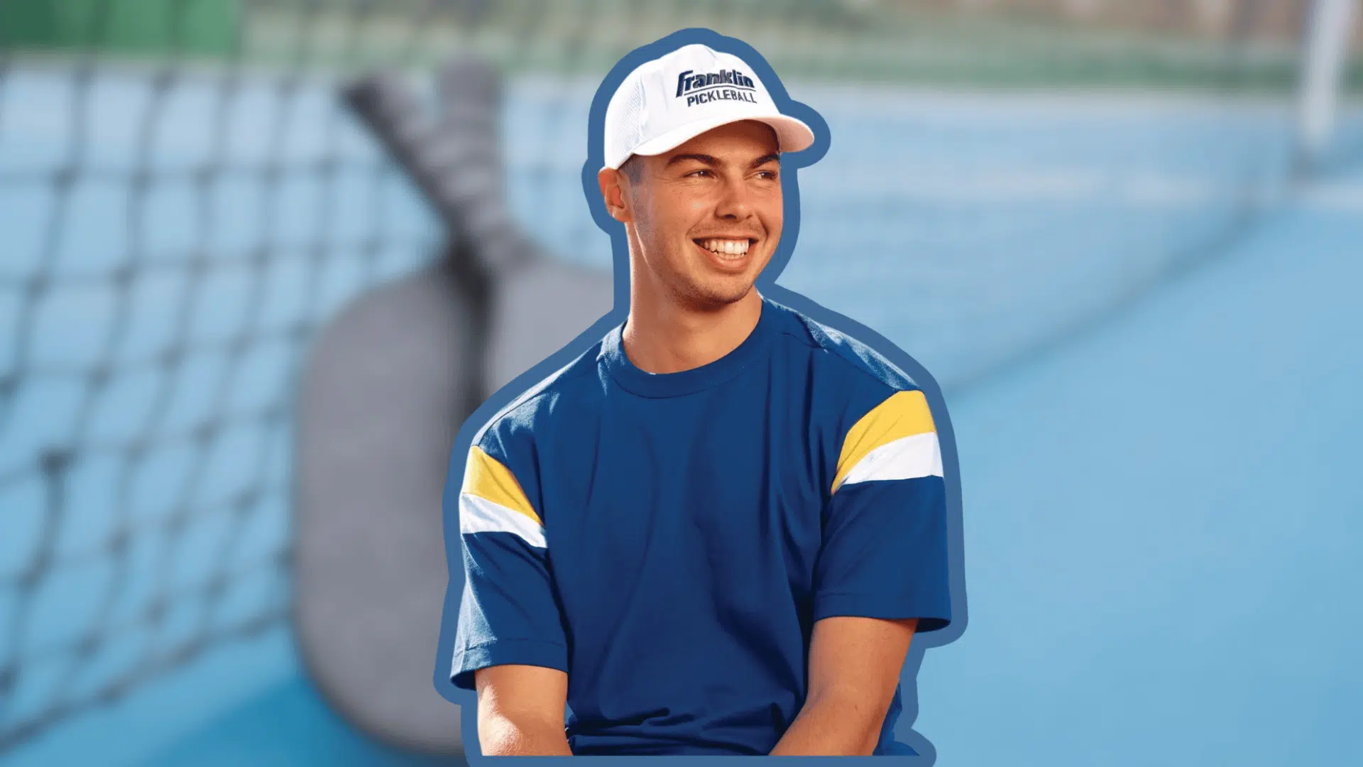 ben johns with a blue and yellow shirt and a white hat is sitting on a tennis court