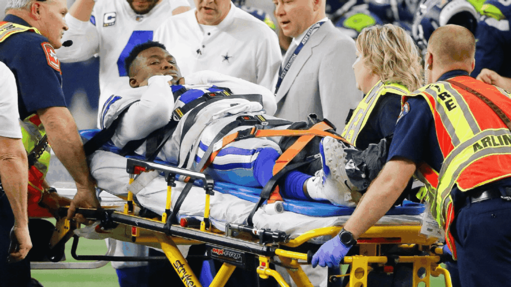 a football player on a stretcher surrounded by medical staff after one of the worst football injuries during an nfl game