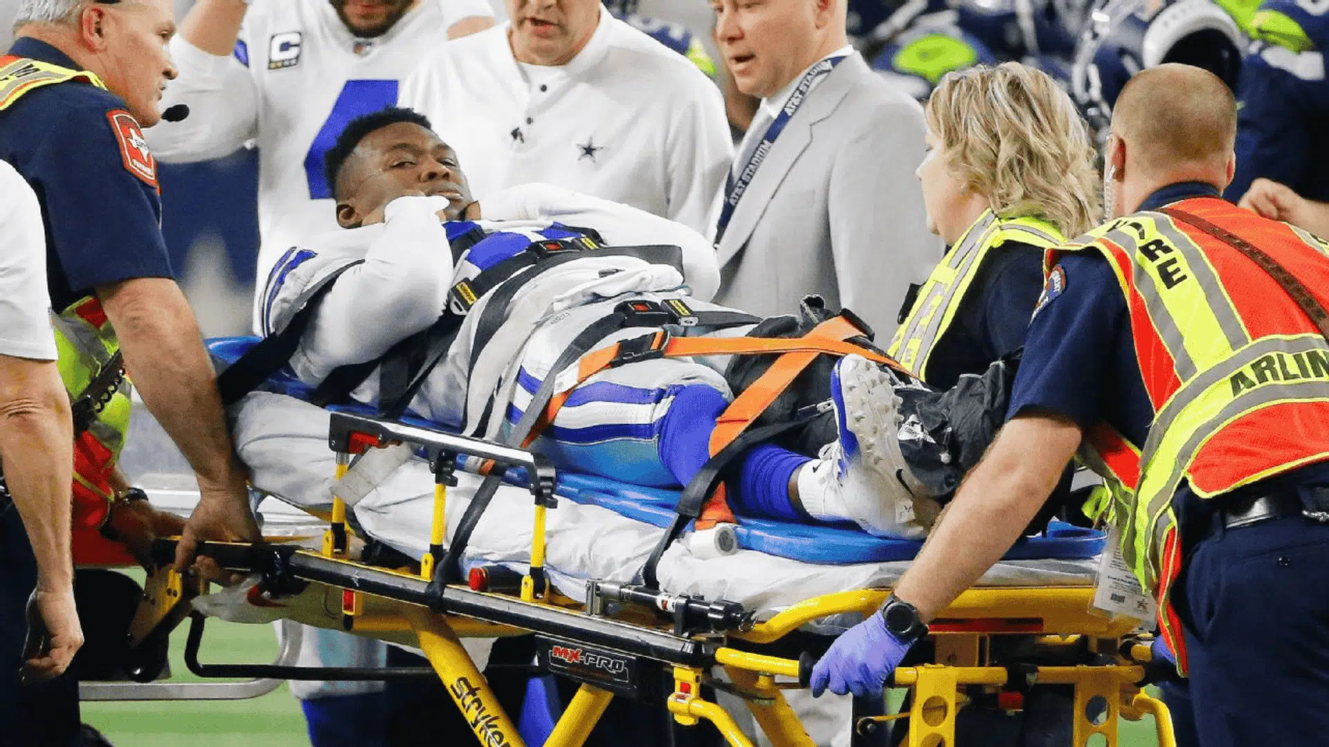 a football player on a stretcher surrounded by medical staff after one of the worst football injuries during an nfl game