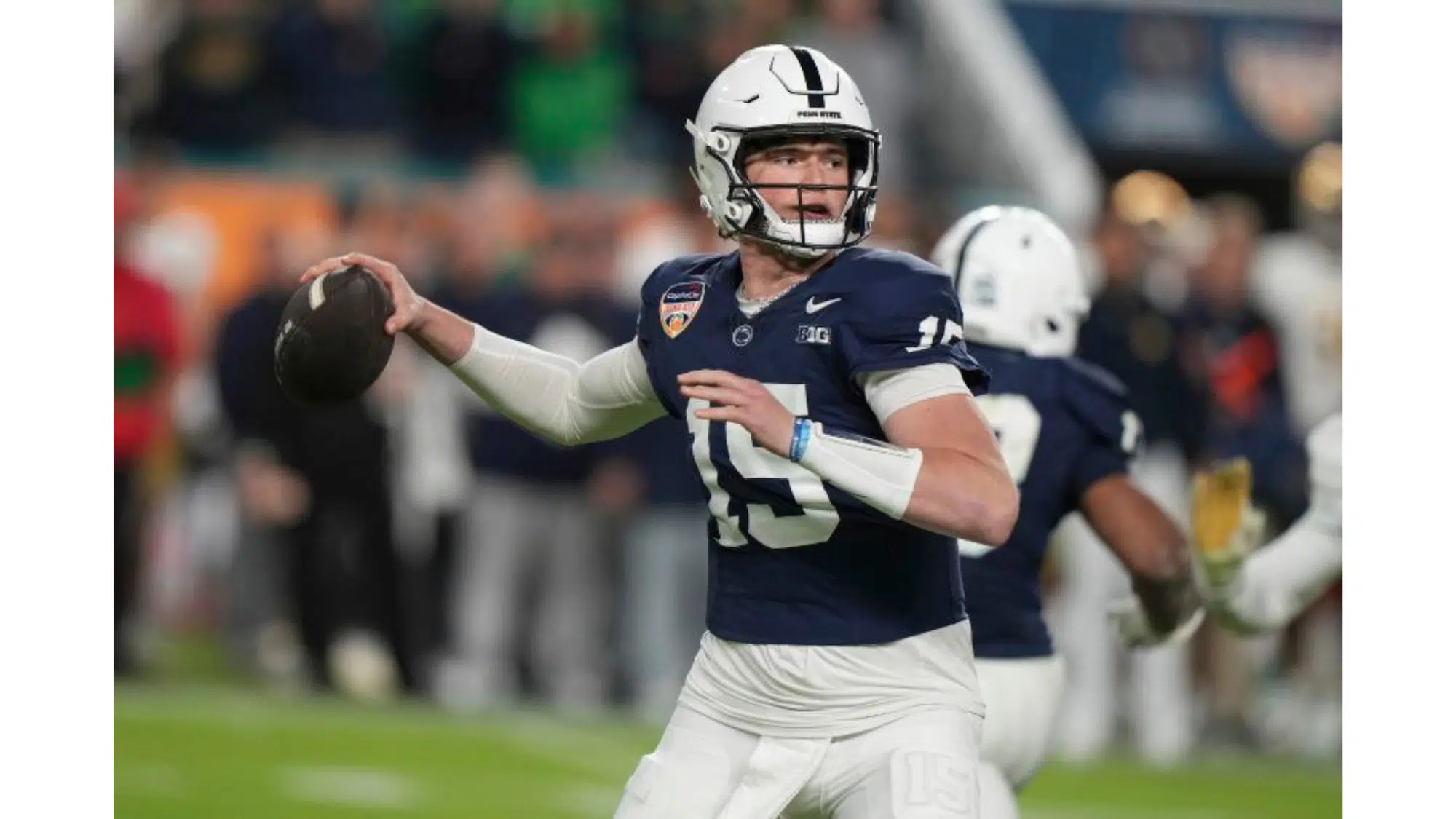 a penn state nil earner football player wearing number 15 prepares to throw a pass during a game with teammates in the background
