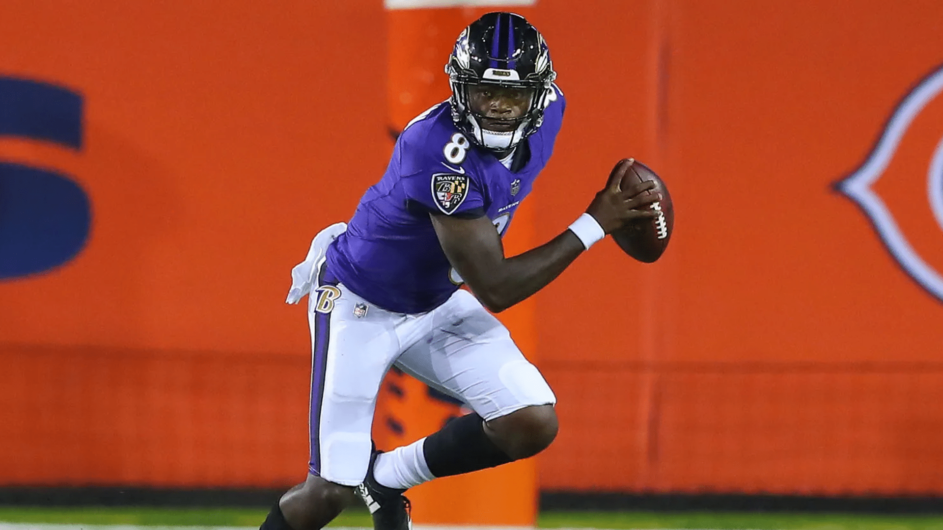 a quarterback runs with the ball, ready to make a play.