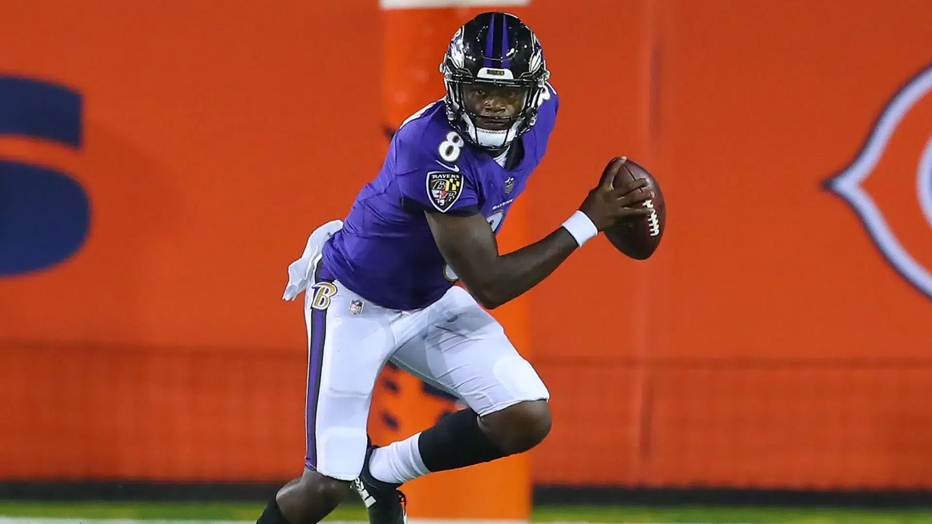 a quarterback runs with the ball, ready to make a play.