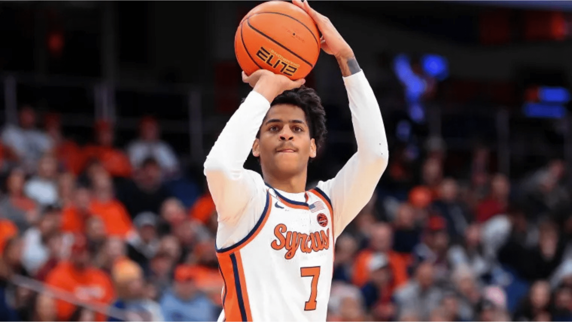 a syracuse basketball top nil earner wearing number 7 prepares to shoot the ball during a game in a crowded arena