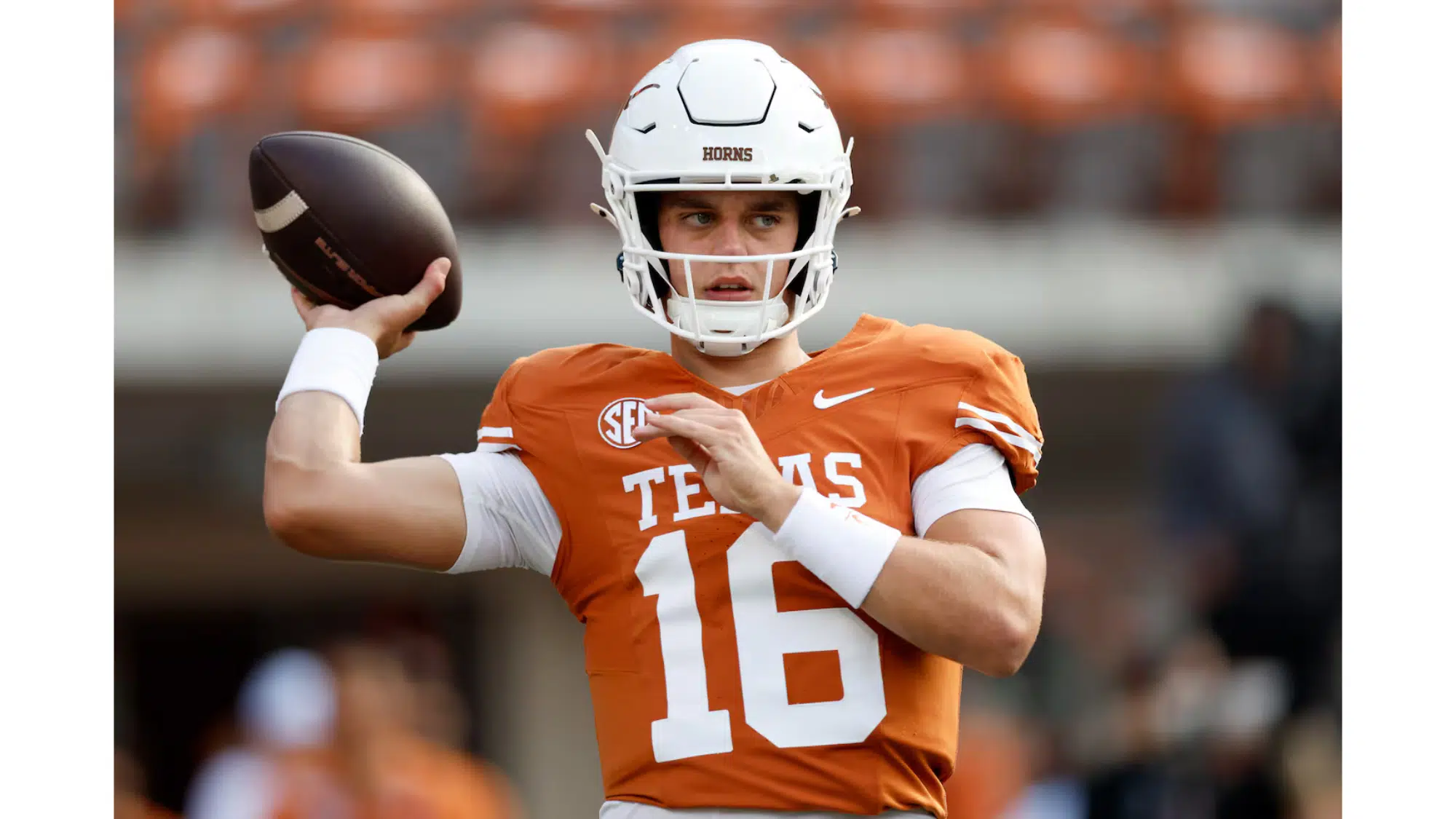 a texas football player wearing number 16 prepares to throw a pass during warmups on the field in a stadium
