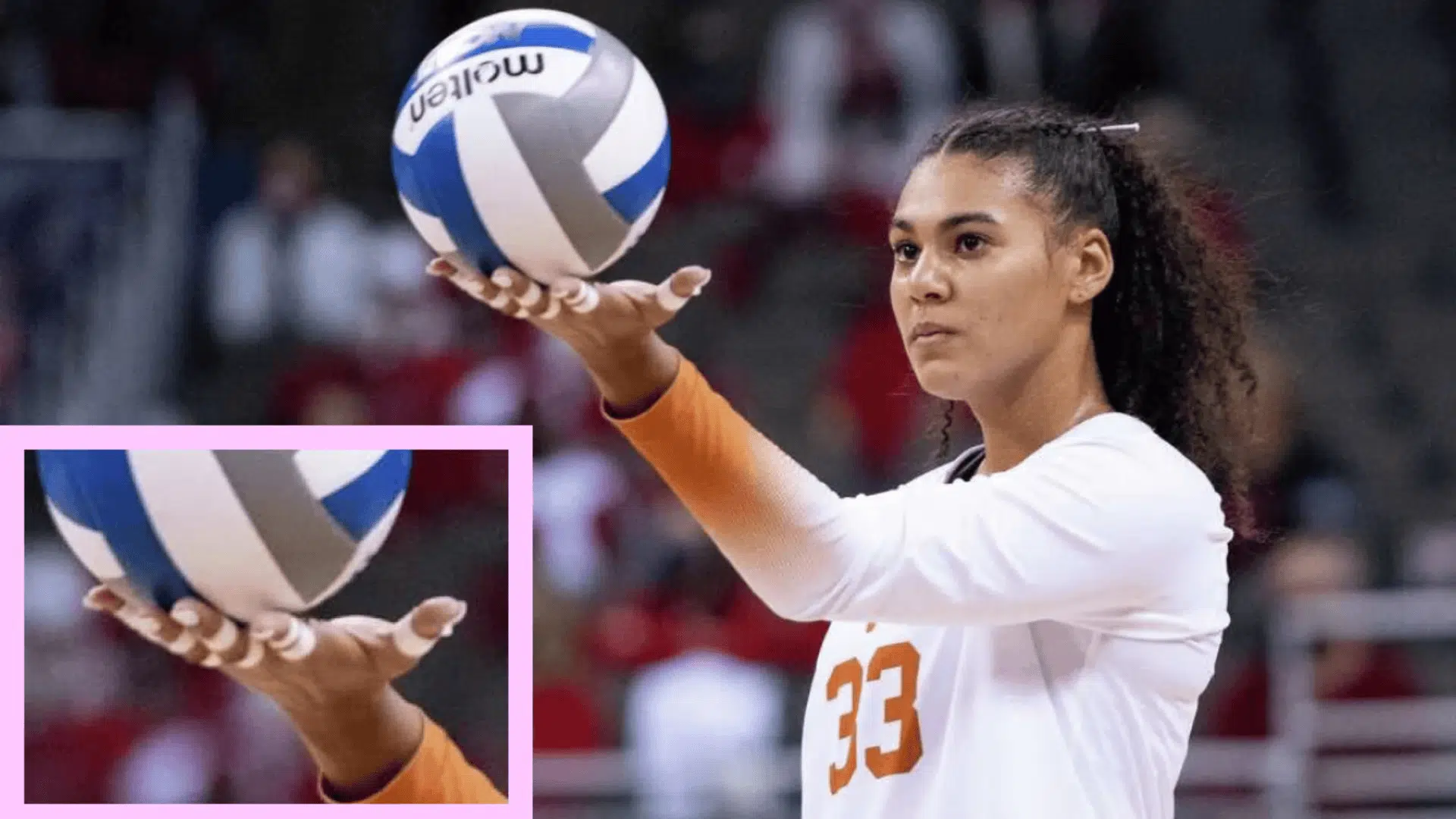 a volleyball player prepares to serve, gripping the ball in a ready position, with the number taping in her fingers