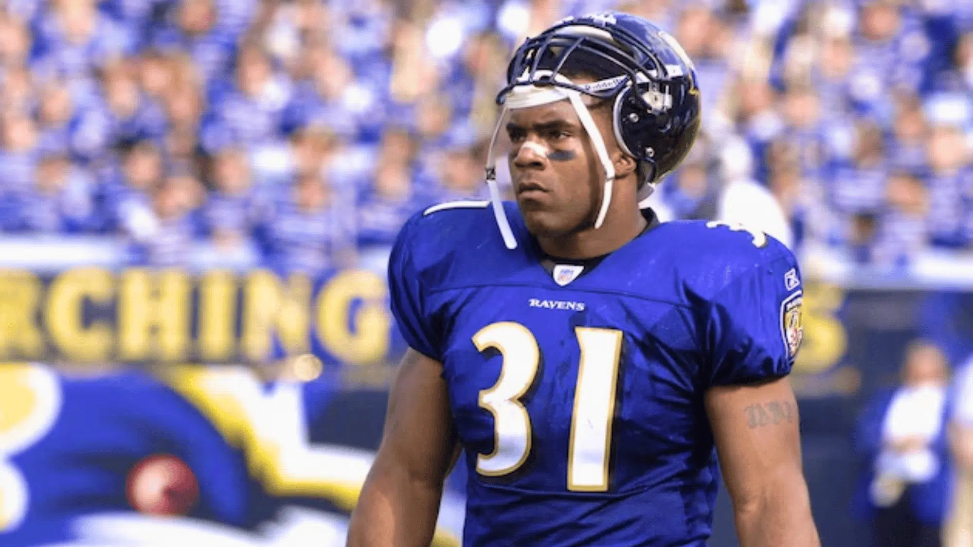 baltimore ravens player wearing number 31 jamal lewis stands on the field with helmet tilted up