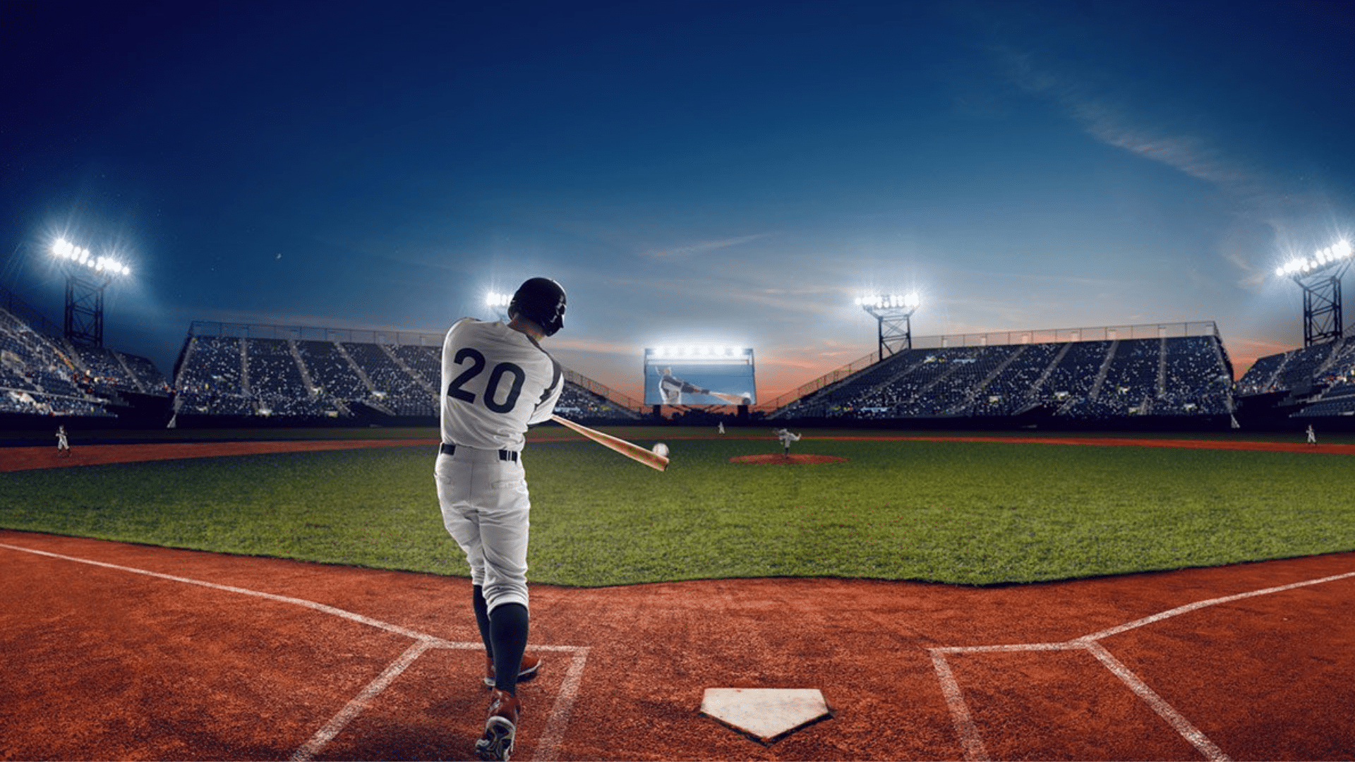 batter swinging bat in night stadium