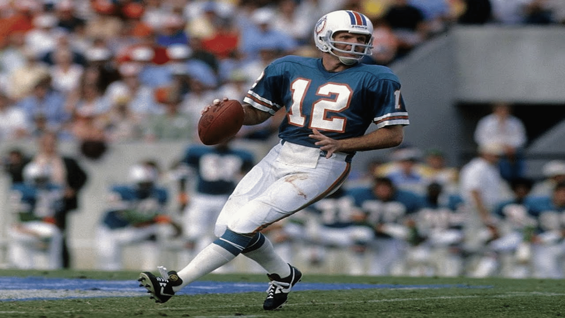 bob griese quarterback rolls out with the ball during a game