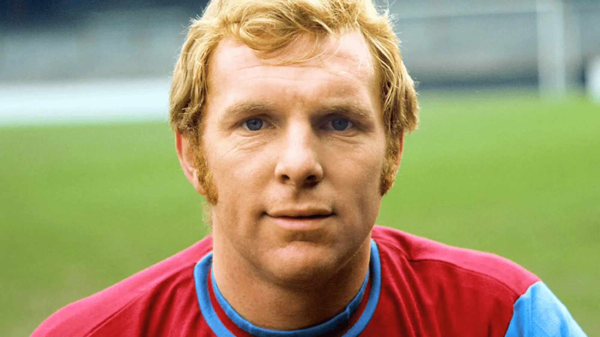 bobby moore in a claret and blue jersey posing for a portrait on the pitch