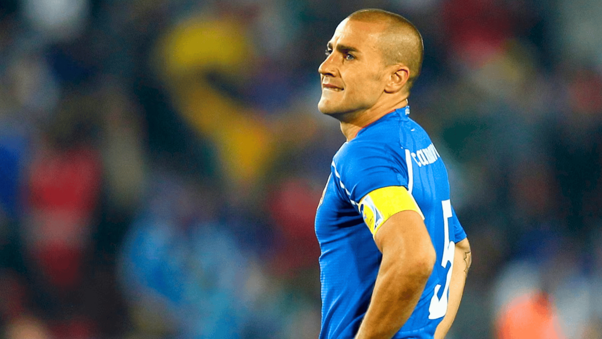 fabio cannavaro in a blue italy jersey wearing a captain armband