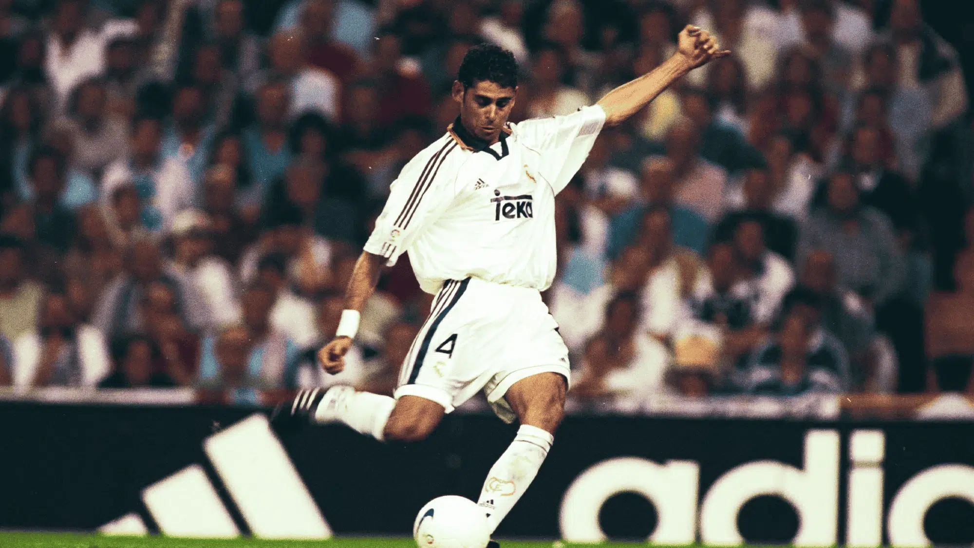 fernando hierro in a white real madrid jersey kicking the ball