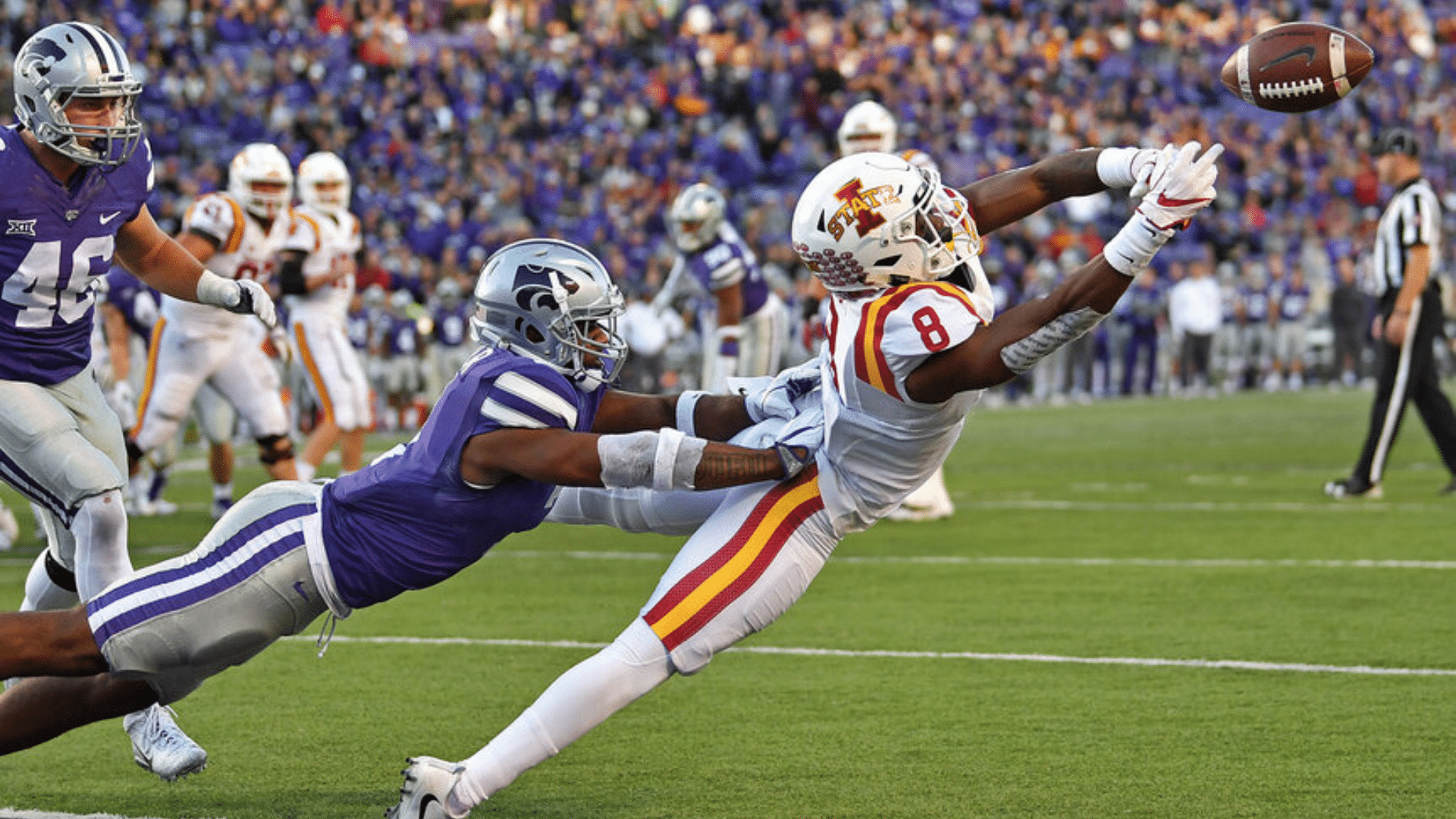 football players receiver diving catch near end zone