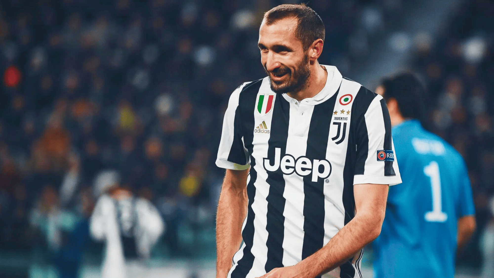 giorgio chiellini in a juventus jersey smiling during a match
