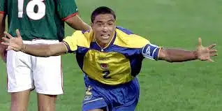 ivan córdoba in an ecuador jersey celebrating with arms outstretched
