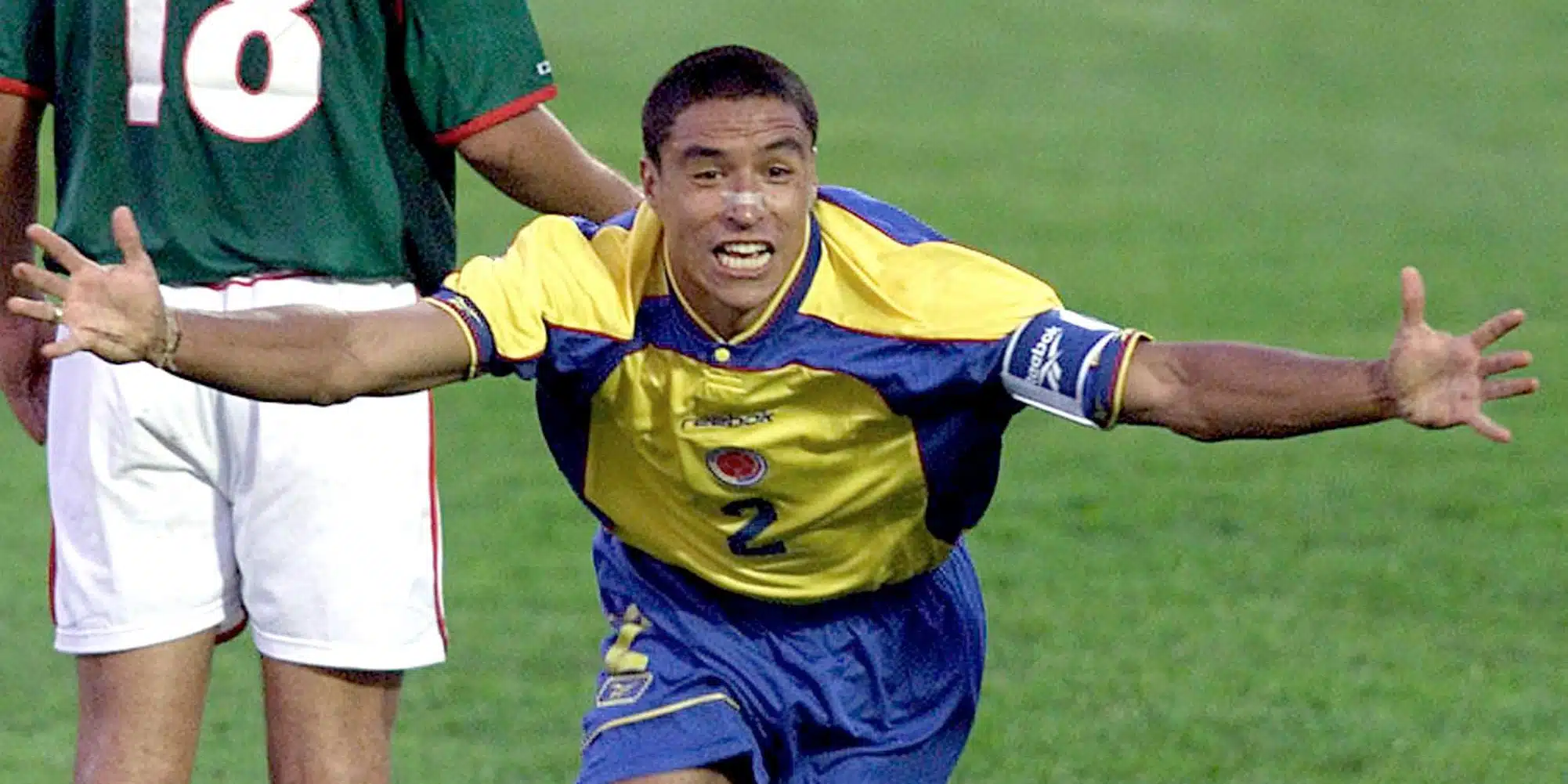 ivan córdoba in an ecuador jersey celebrating with arms outstretched