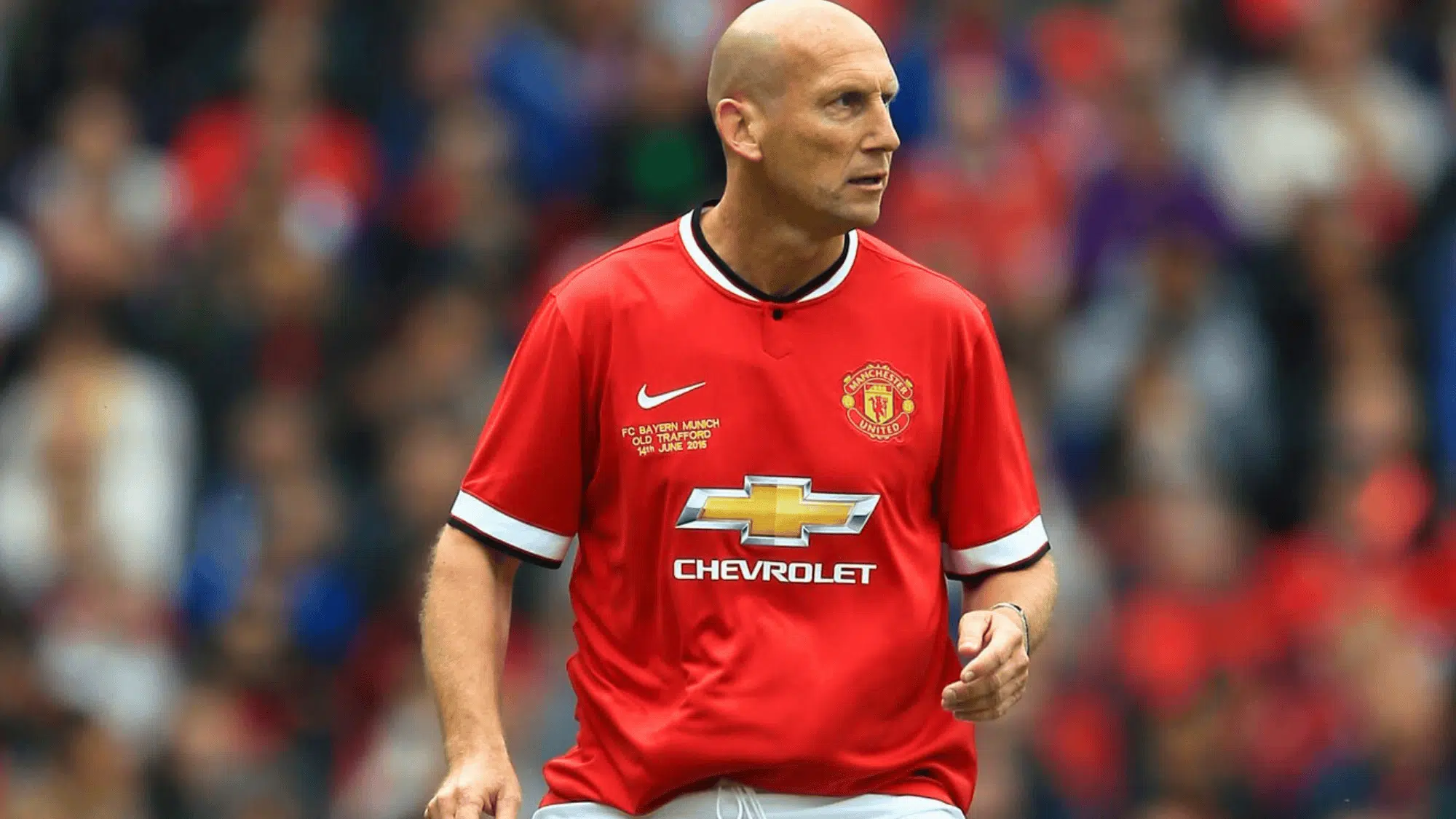 jaap stam in a red manchester united jersey standing on the field