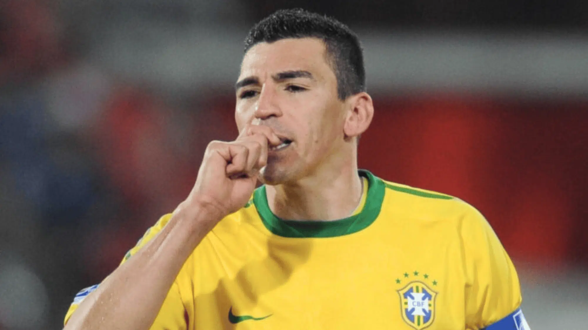 lucio in national team colors signaling to the crowd with a unique gesture