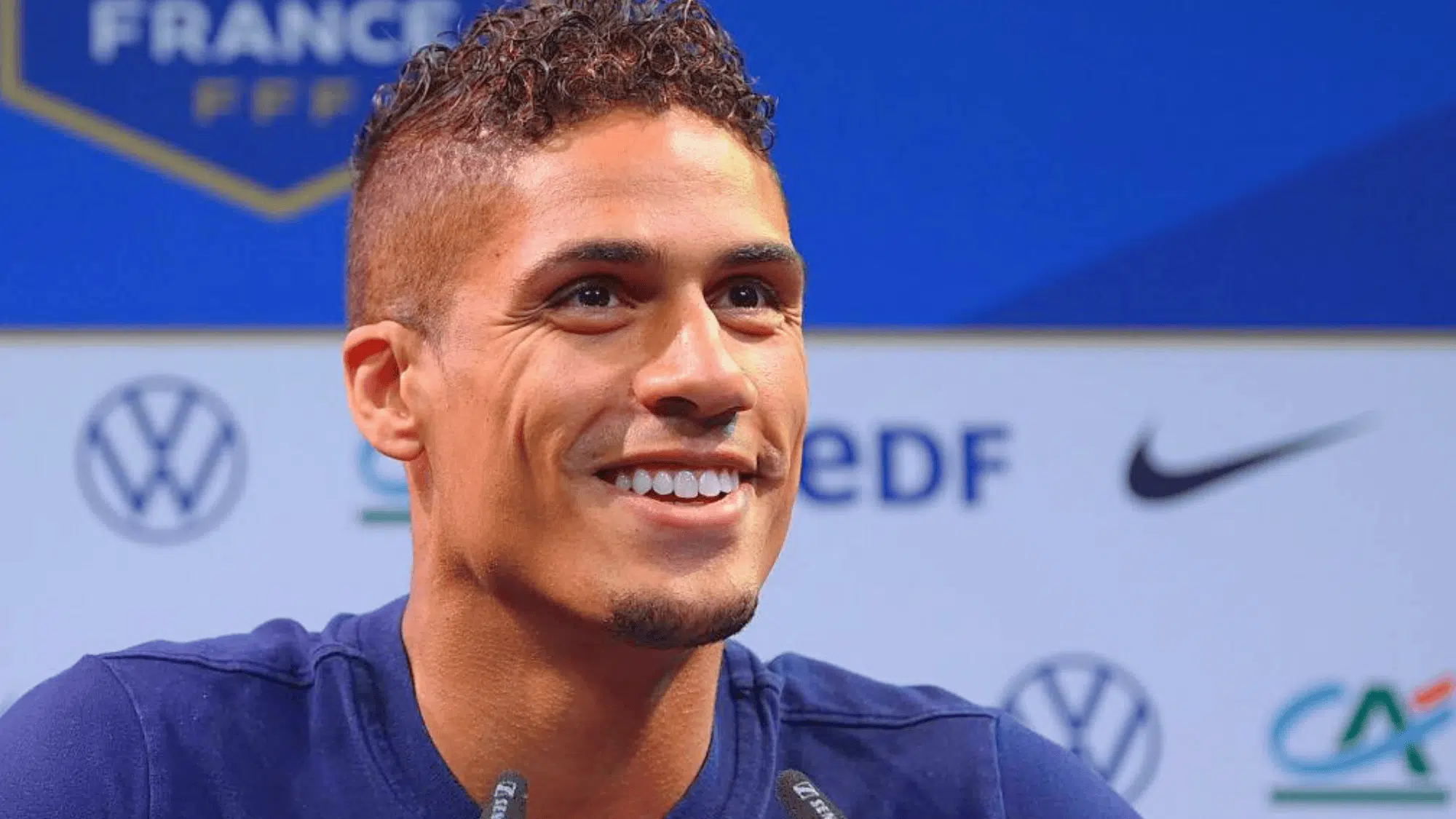 raphael varane smiling during a france press conference