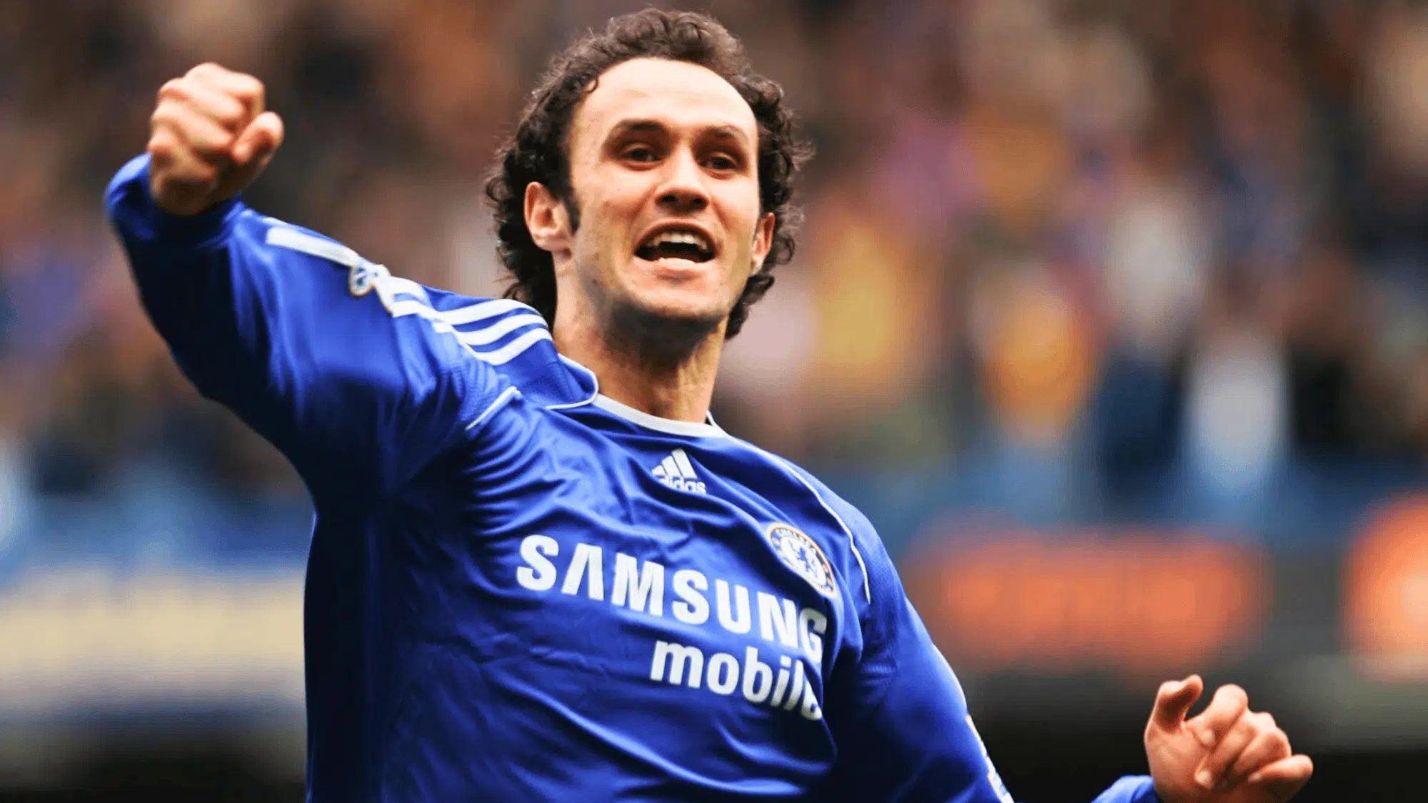 ricardo carvalho in a blue chelsea jersey celebrating with his arm raised