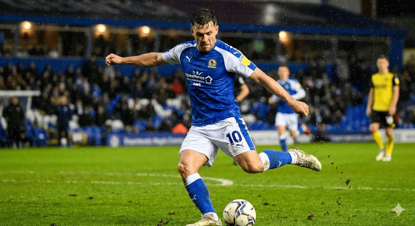 soccer player in a blue jersey striking the ball on a rainy stadium field with grass flying as fans watch from the stands
