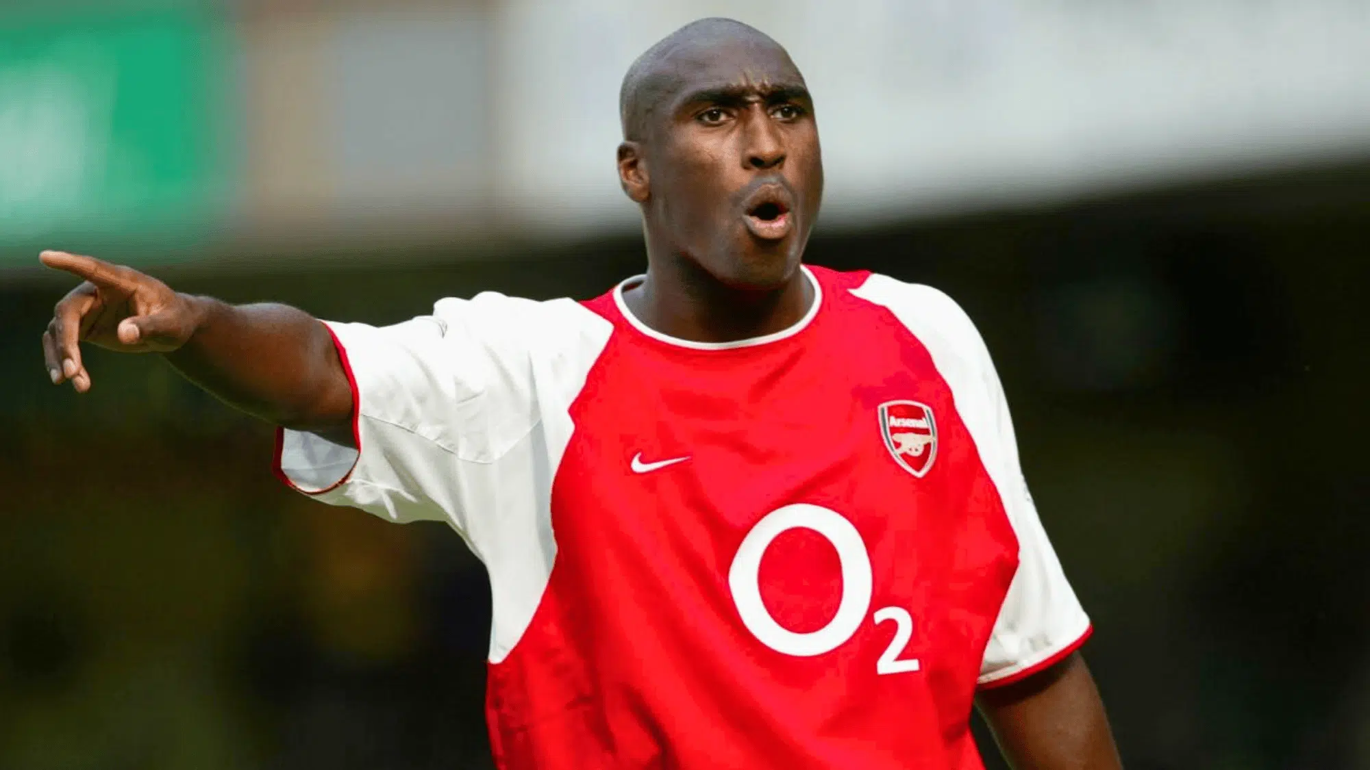 sol campbell passionately gesturing during a match while wearing an Arsenal kit