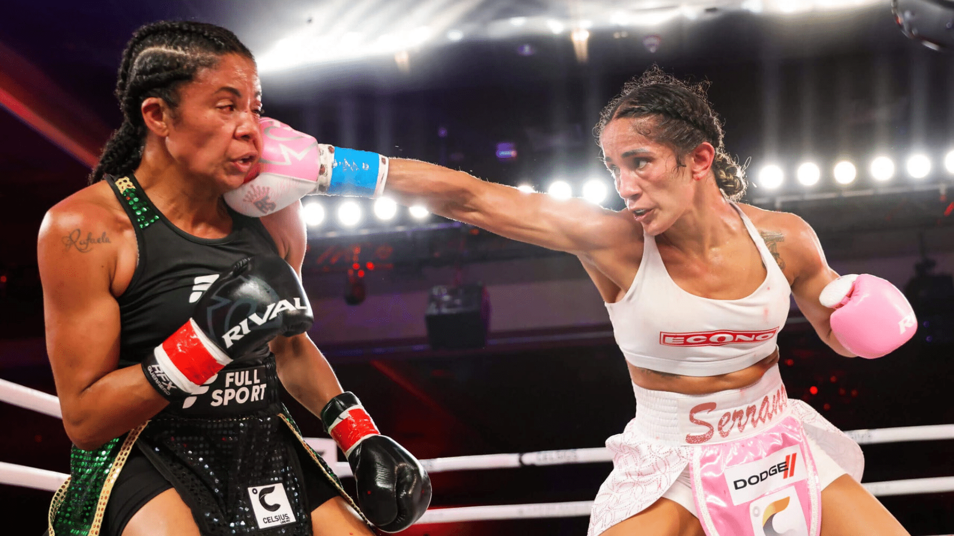 two female boxers in the ring as one lands a sharp jab to the face while the other attempts to guard 