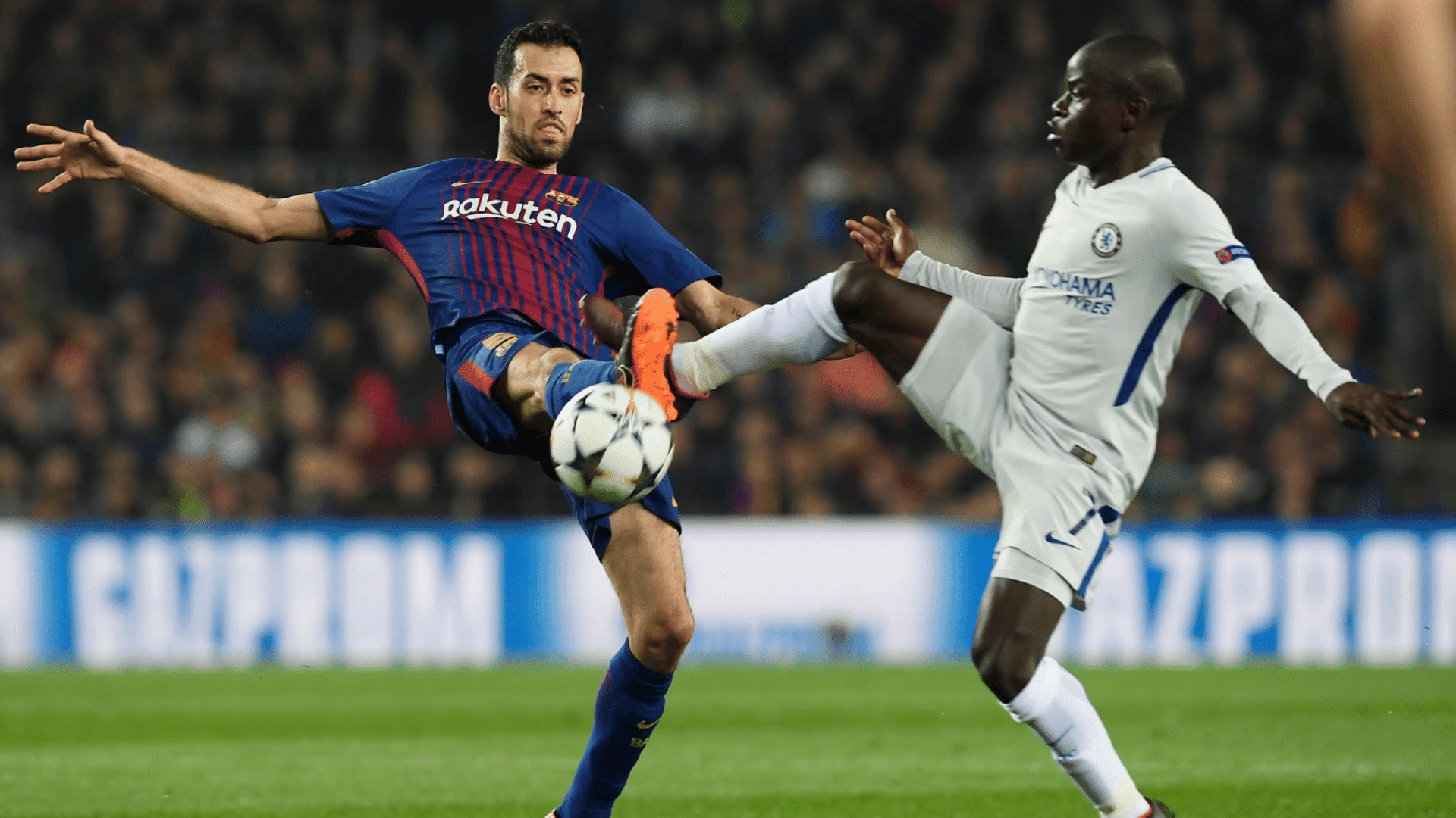 two midfielders contest ball during match