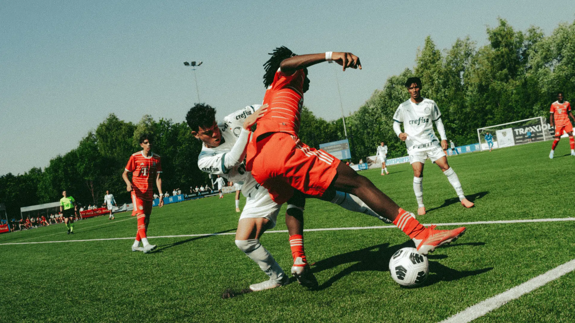 two soccer players battling for the ball during a match demonstrating how to improve soccer skills through active play