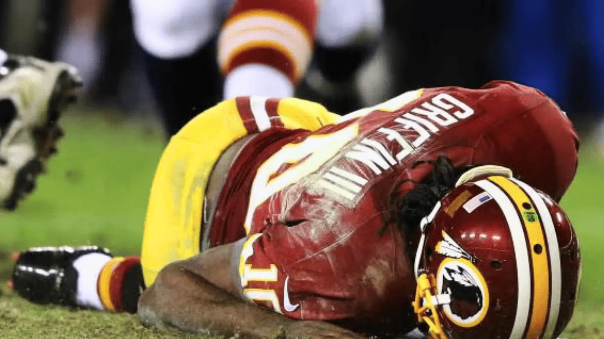 washington player rg lll lying on the field holding his shoulder after a play