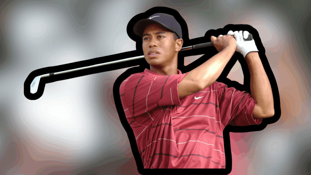 Tiger Woods private jet golfer in red shirt swinging club with focused expression and blurred background behind him