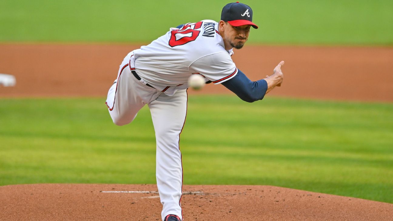 baseball pitcher in an Atlanta Braves uniform delivering types of pitches from the mound during a game on a grass field