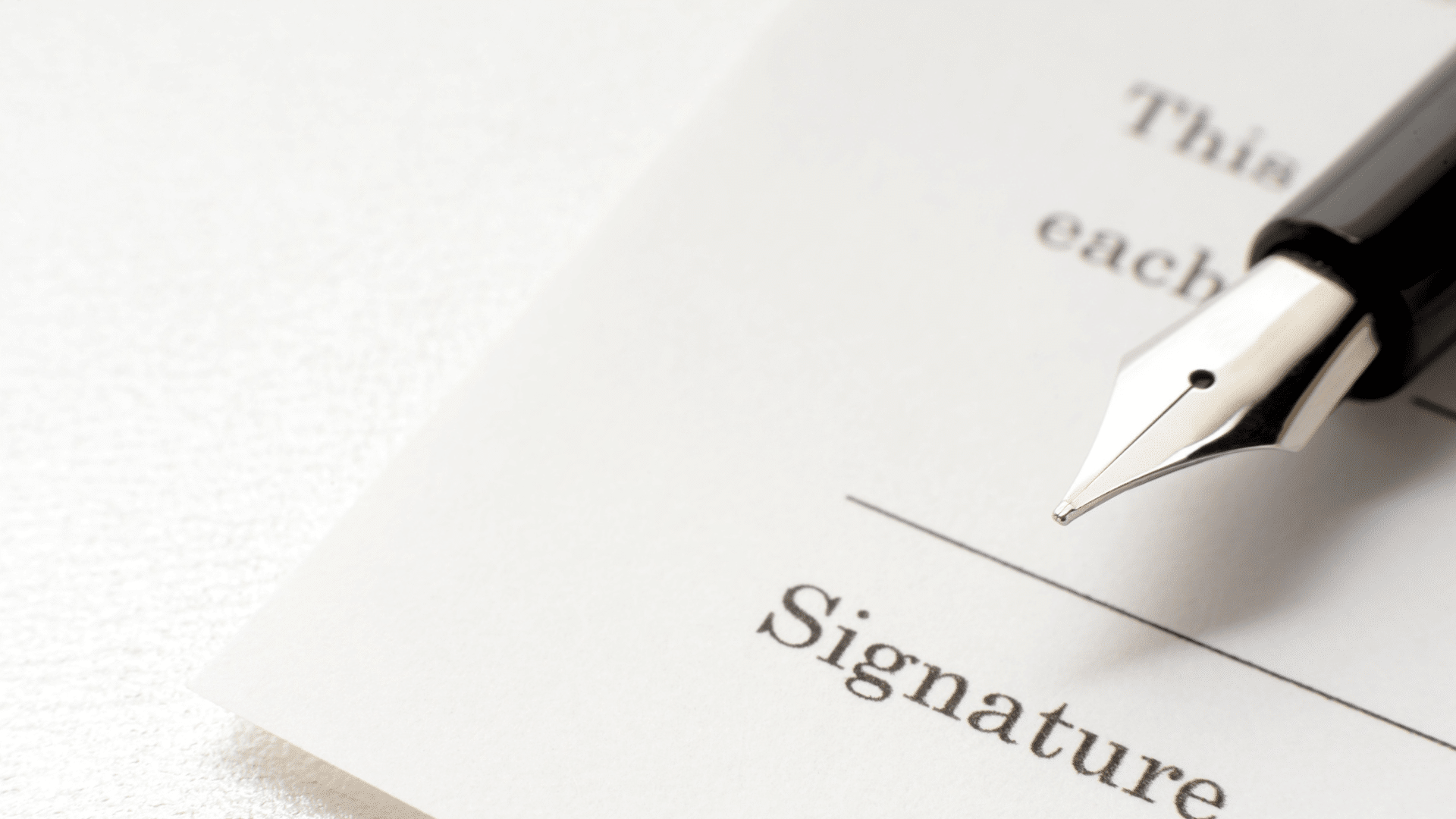 close up of pen tip near signature line on paper who pays nil money taxes deals