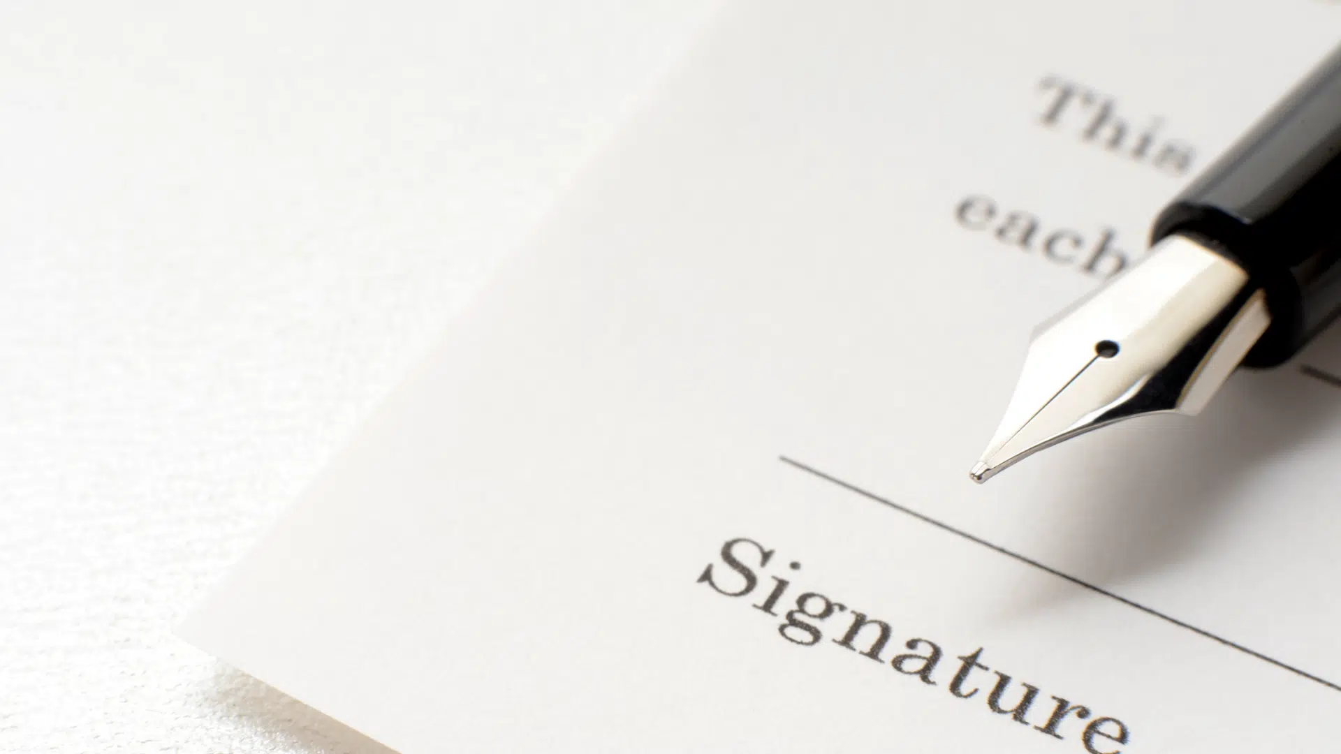 close up of pen tip near signature line on paper who pays nil money taxes deals