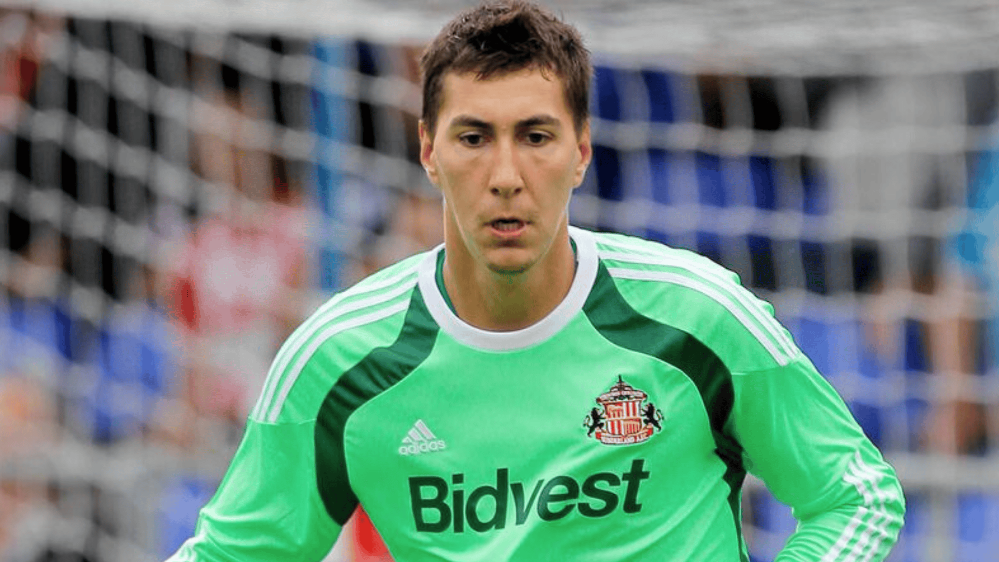 costel pantilimon is in a green goalkeeper kit likely playing for Sunderland