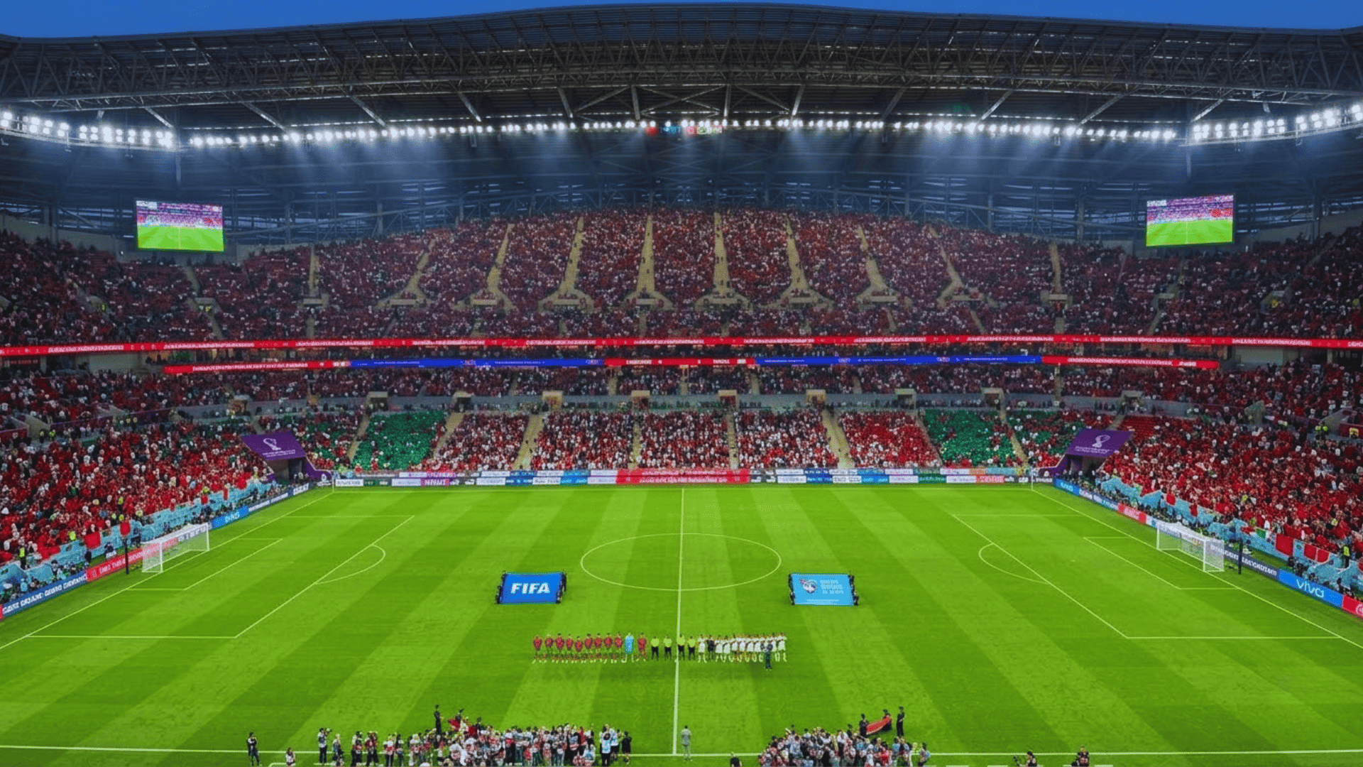 football stadium packed with fans teams lined up before match kickoff