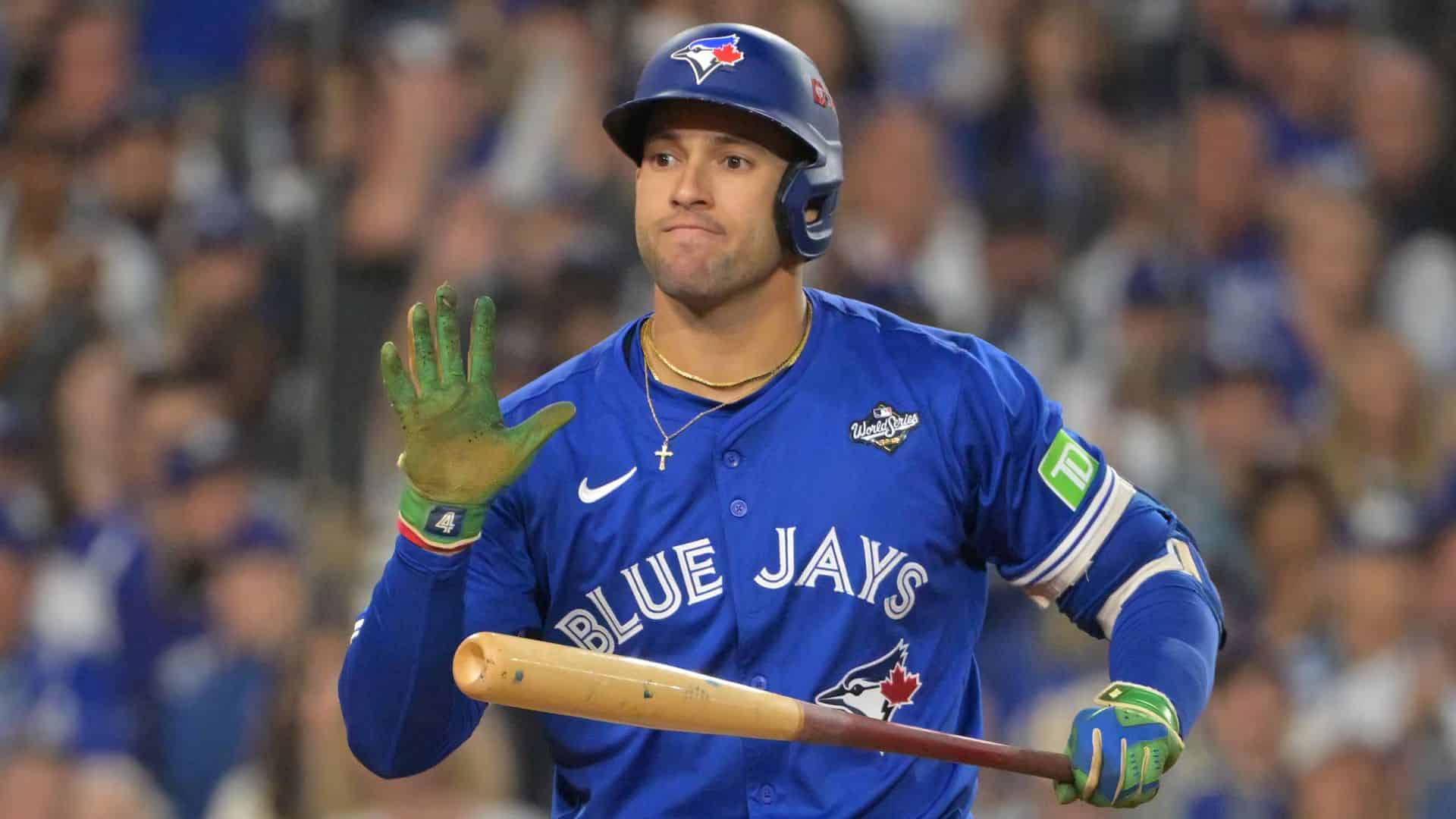 george springer among the oldest active mlb players holding bat and raising hand in blue jays uniform