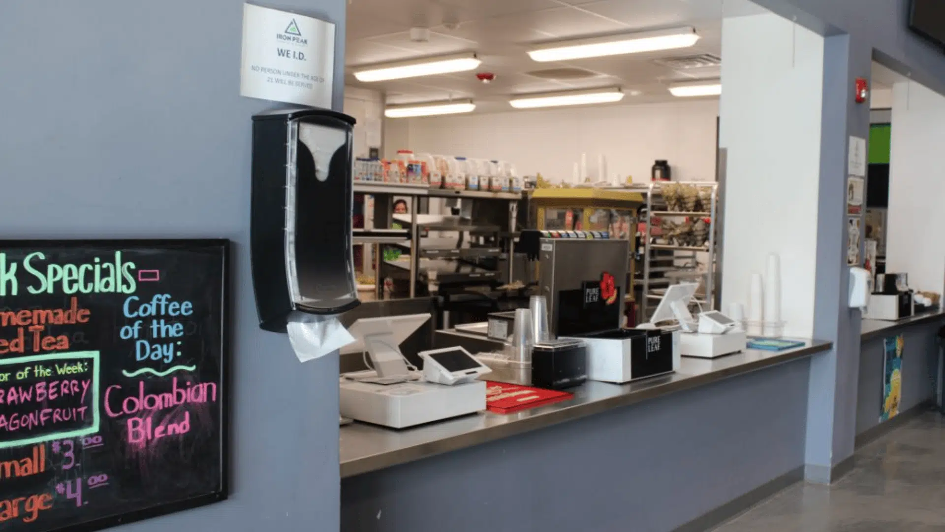 iron peak sport event cafe counter with registers drink machines paper towel dispenser menu board and kitchen prep area