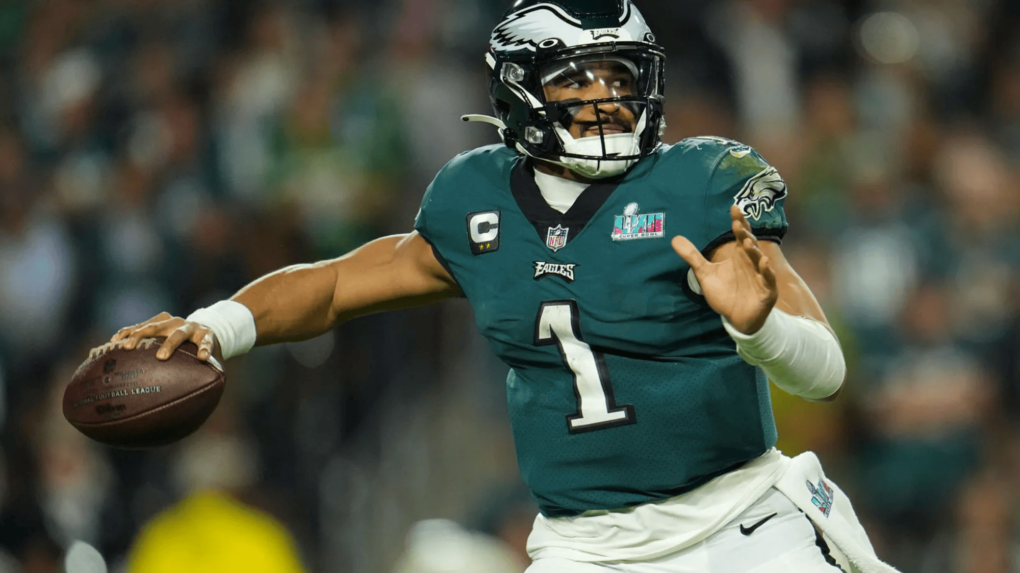 jalen hurts in green jersey poised mid throw during a game, focused