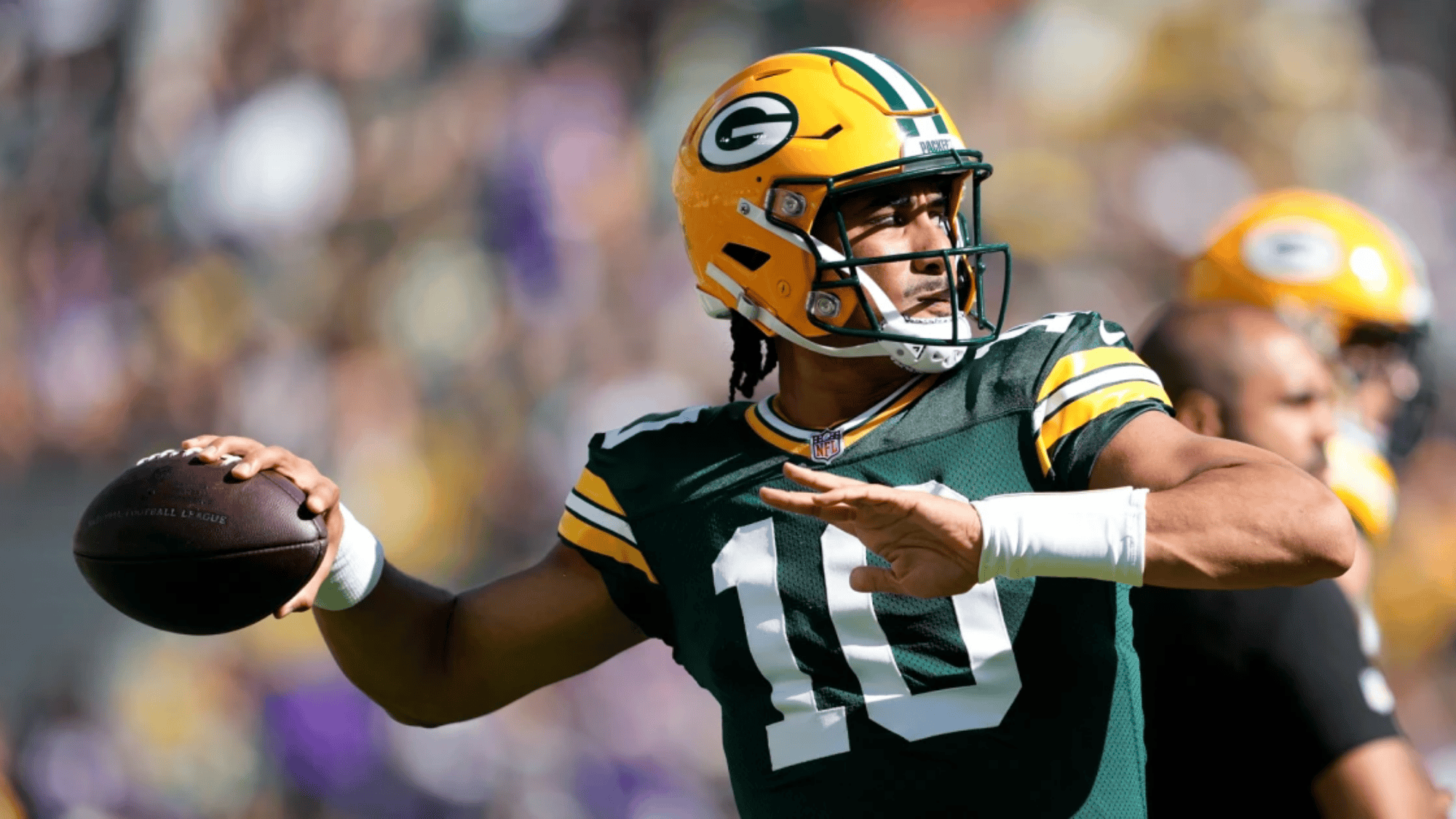 jordan love in a green bay packers uniform number 10 prepares to throw a pass