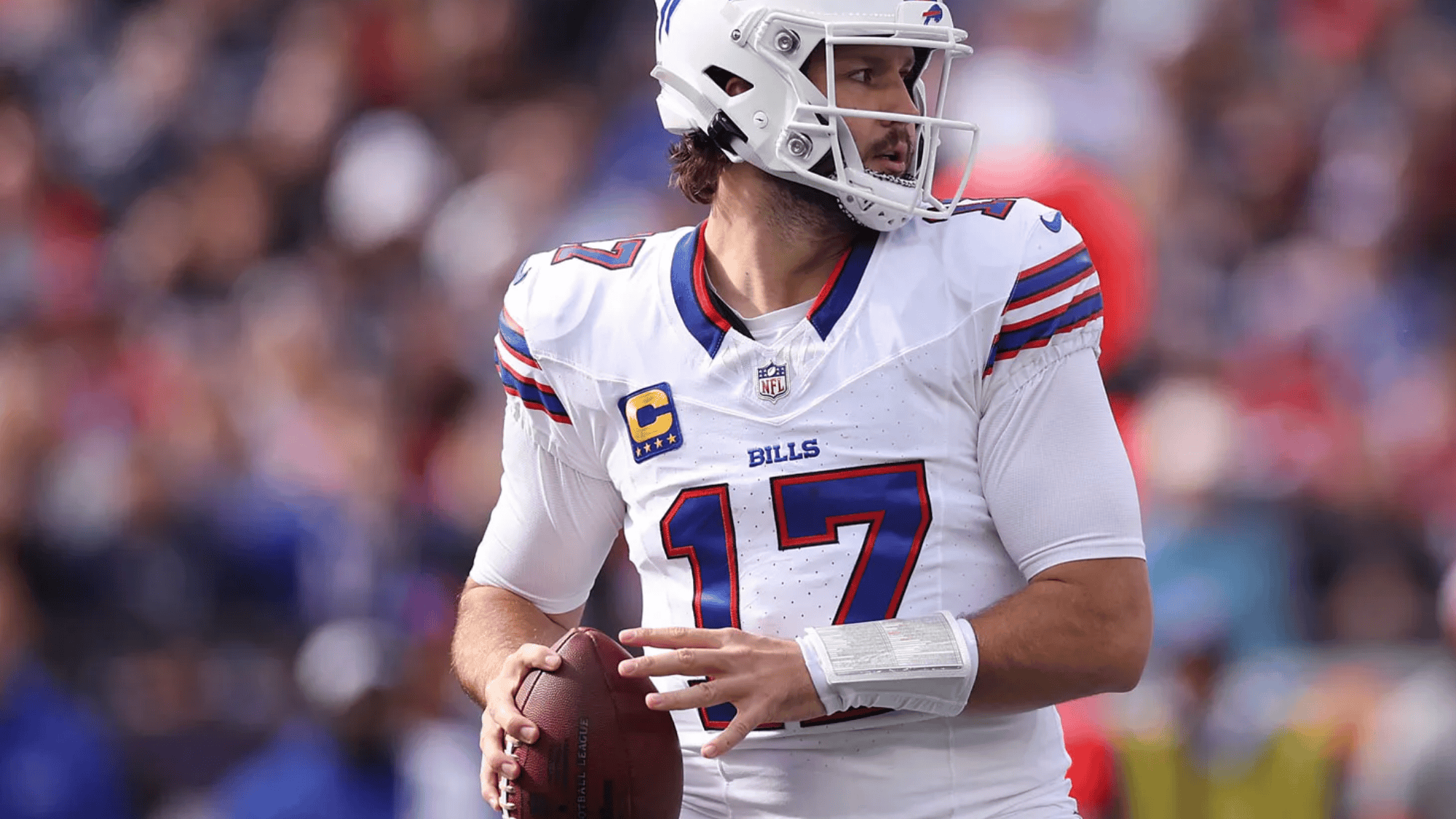 josh allen in a white and blue uniform number 17 prepares to throw a pass