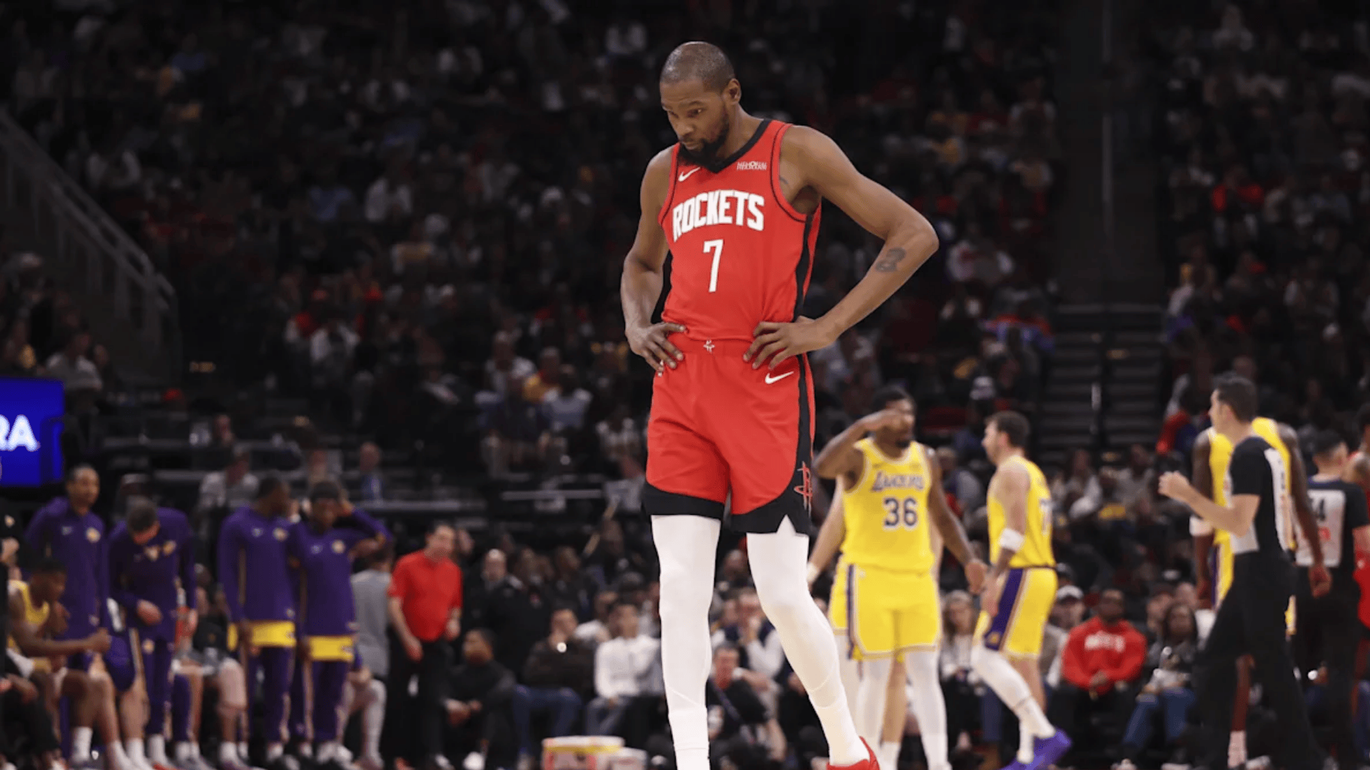 kevin durant in Houston jersey walking on court during nba game with players and crowd in background