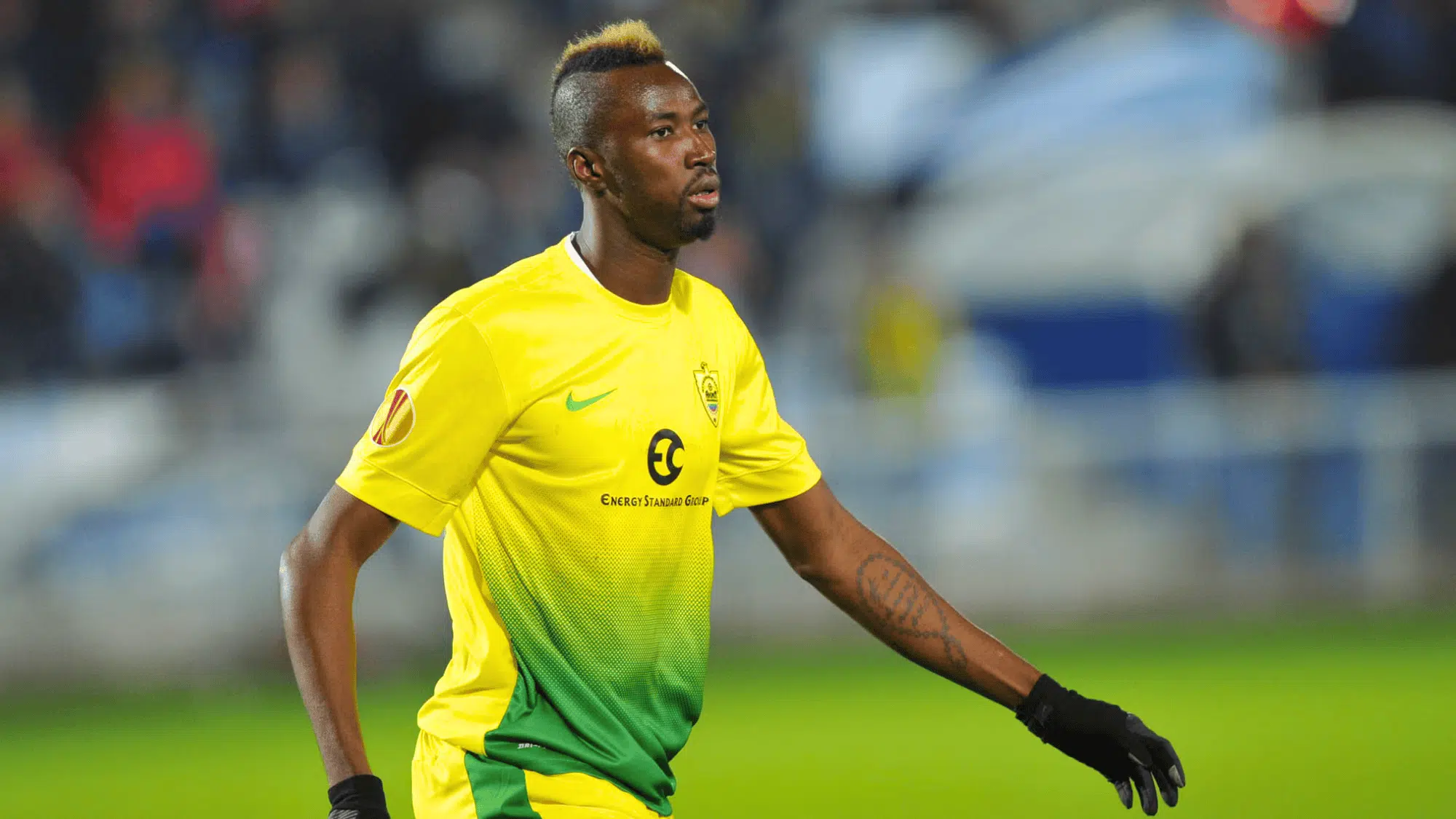lacina traoré is wearing a yellow green kit likely playing for the Kazakhstani club FC Astana