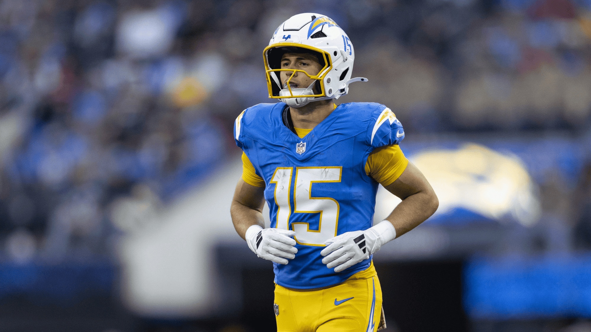 ladd mcconkey in a bright blue and yellow uniform and white helmet jogs on the field