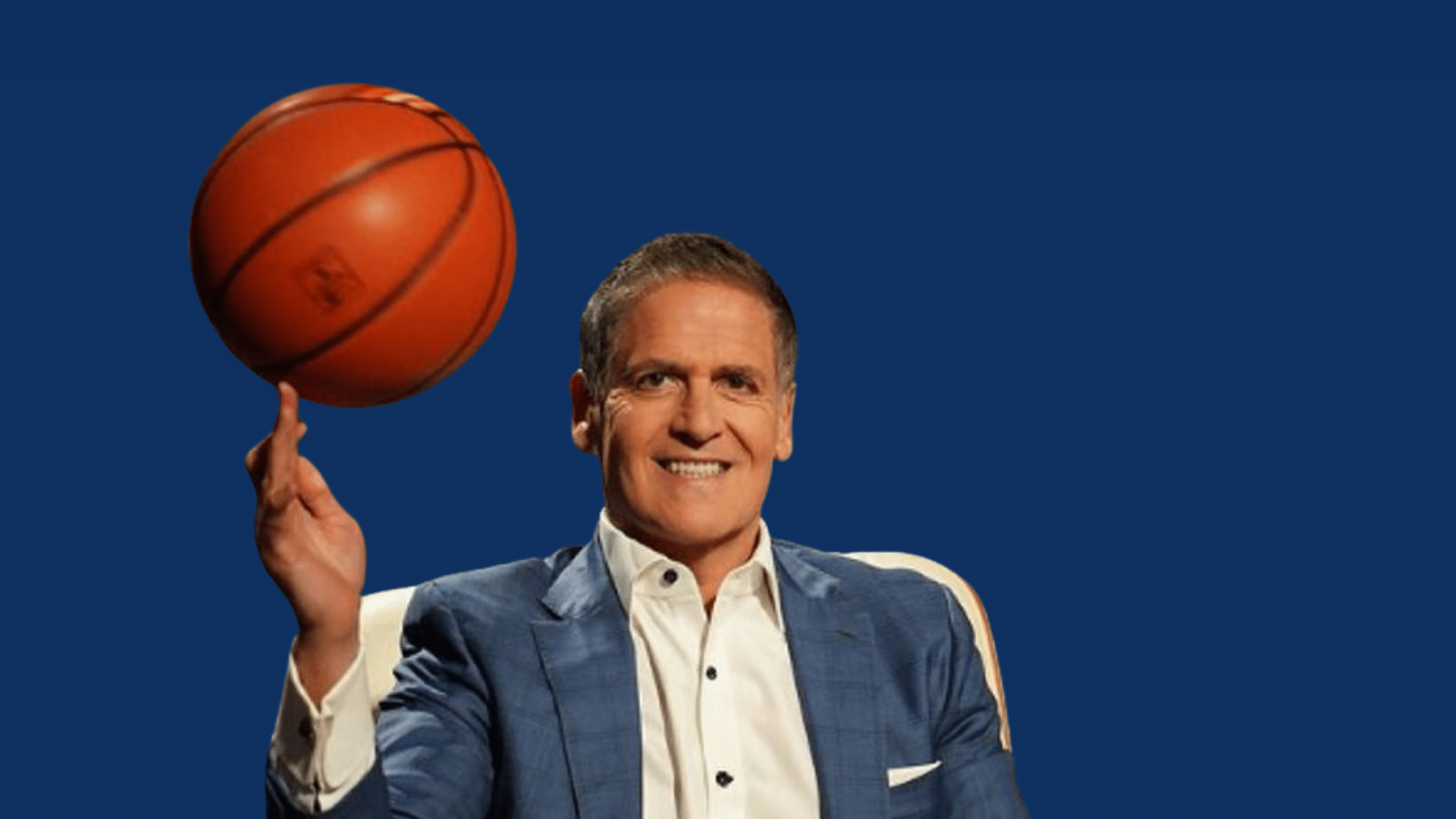 mark cuban smiling while spinning a basketball on his finger in a studio