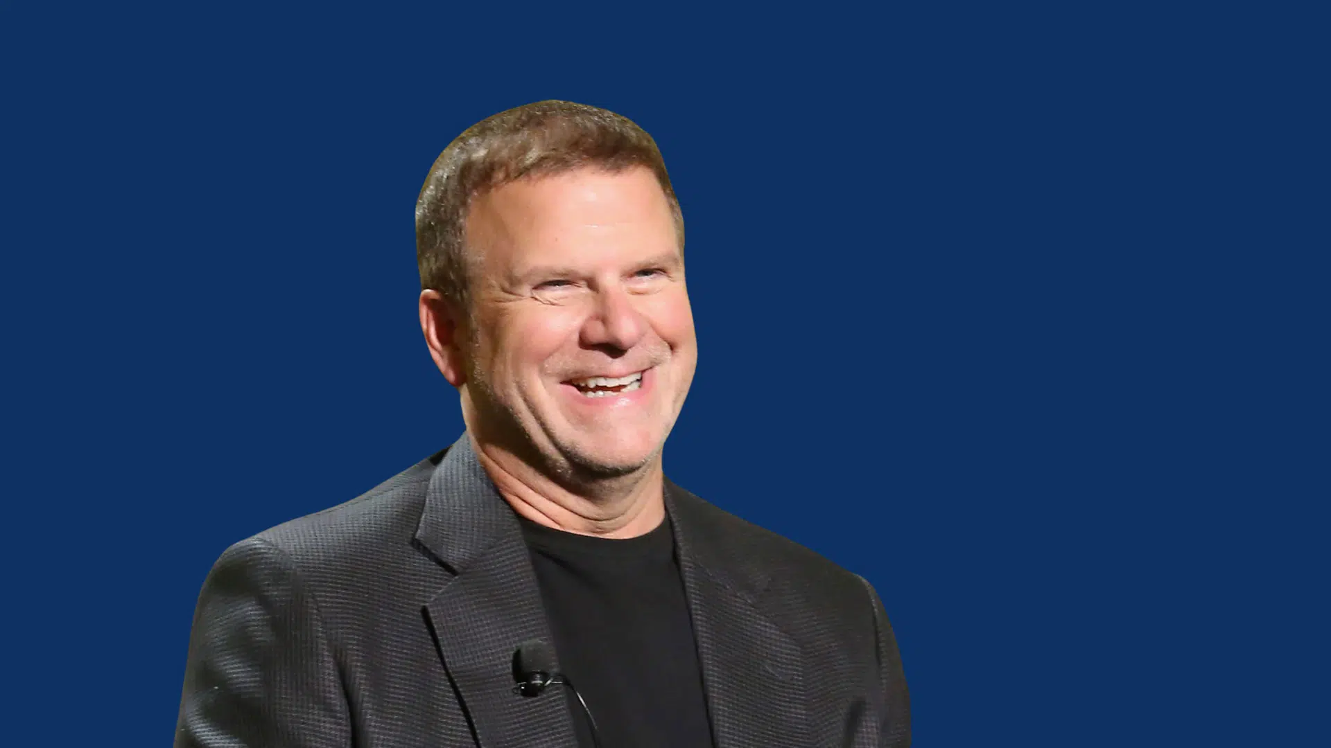 tilman fertitta smiling while giving an interview on stage