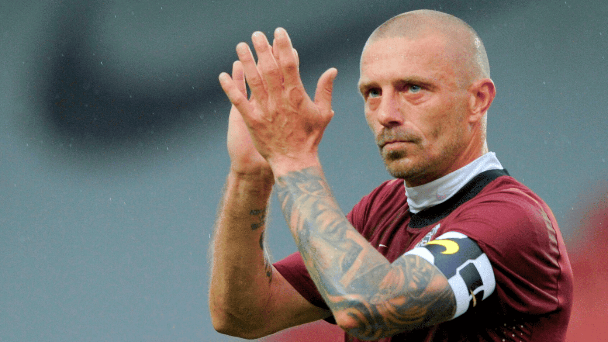 tomáš řepka is celebrating after a goal in a maroon kit possibly with a Serbian team