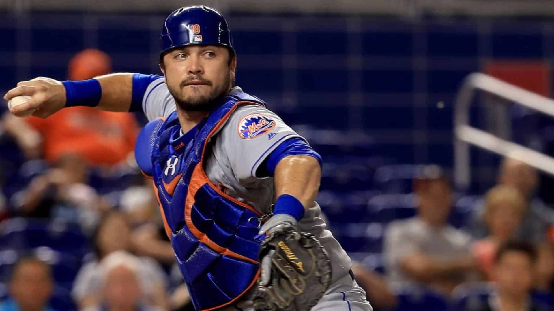 travis darnaud among the oldest active mlb players throwing baseball wearing catcher gear during game