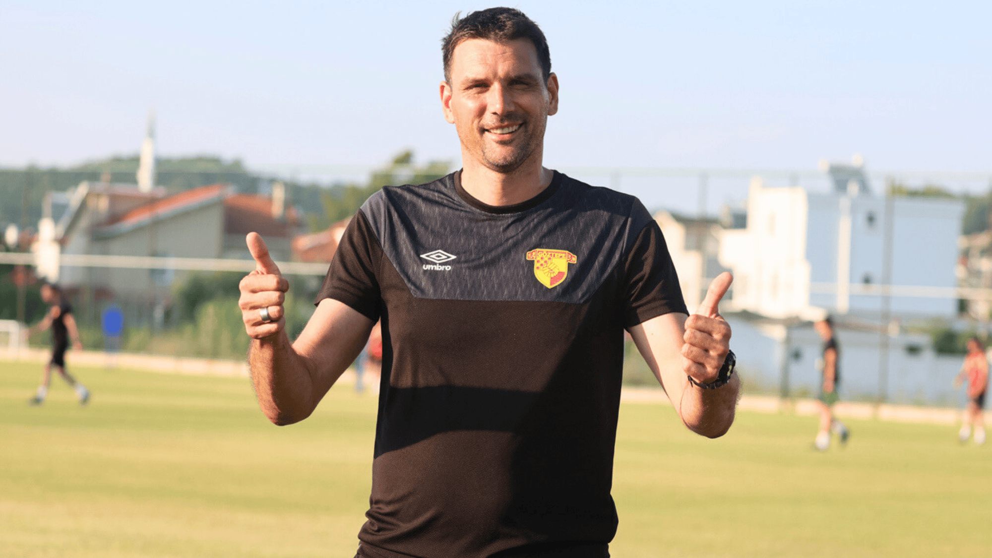 vanja iveša wearing a black training shirt with the clubs logo standing on the field