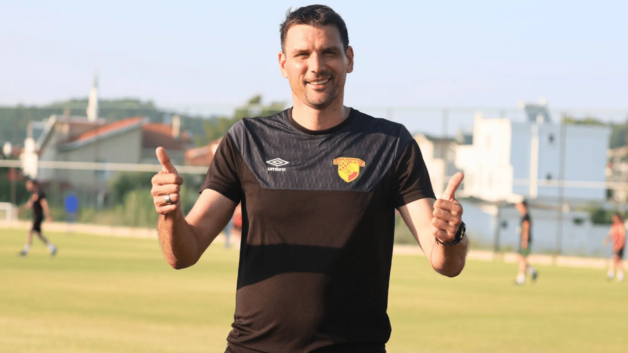 vanja iveša wearing a black training shirt with the clubs logo standing on the field