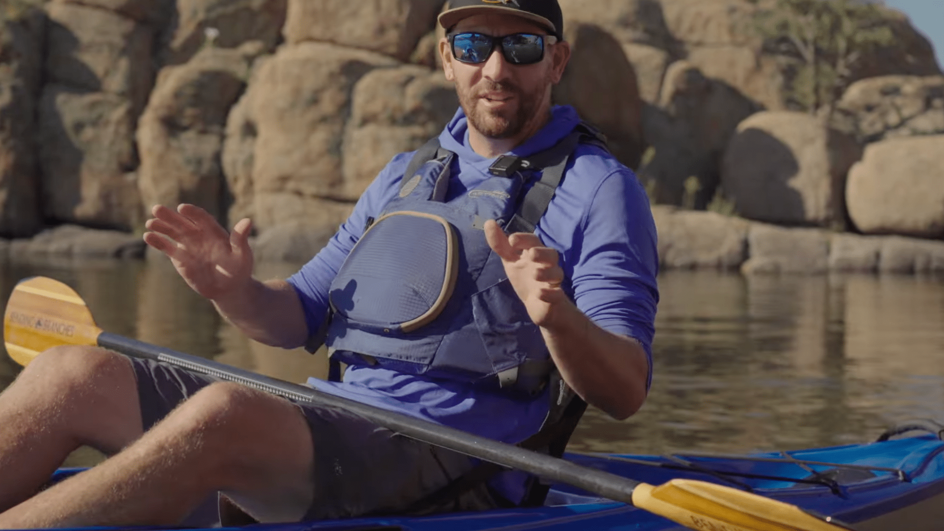 a person sits in a kayak adjusting footrests and seating position to maintain balance and comfort